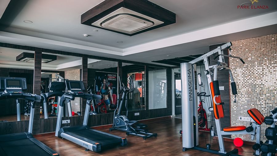 a gym with a treadmill  and other gym equipment - Hotel Park Elanza, Chennai