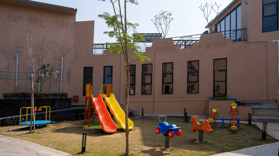 Family-friendly outdoor play area with colorful slides, spring riders, and recreational equipment designed for children's entertainment at Hotel Sonar Bangla Ajodhya Hills.