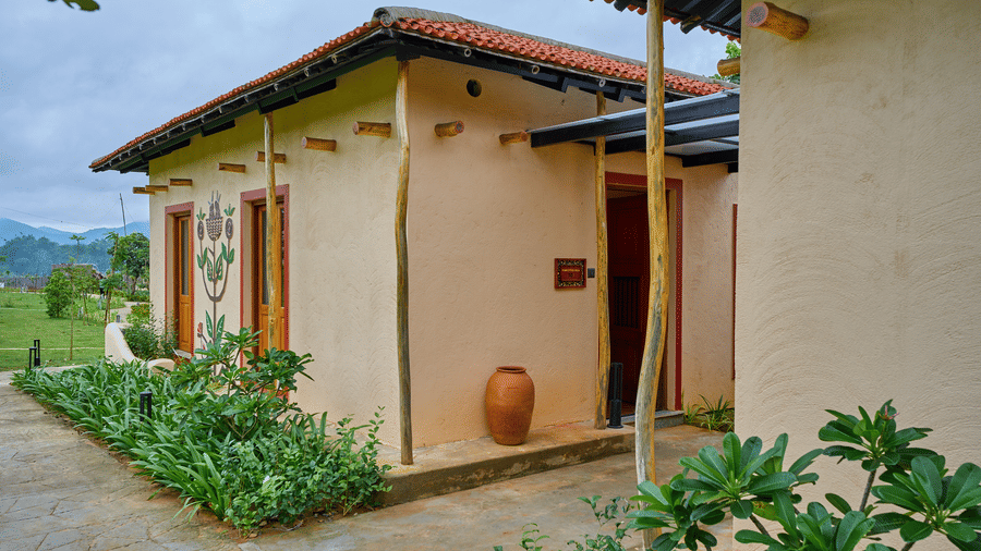 A building exterior featuring a terracotta roof and a paved path at Hotel Sonar Bangla, Ajodhya Hills.