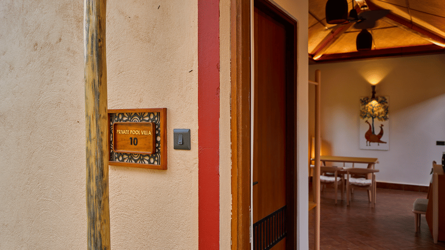 A doorway view featuring an open wooden door leading into a room at Hotel Sonar Bangla, Ajodhya Hills.