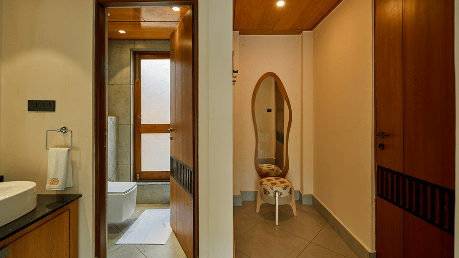An indoor hallway featuring a doorway to a bathroom and a standing mirror at the end at Hotel Sonar Bangla, Ajodhya Hills.