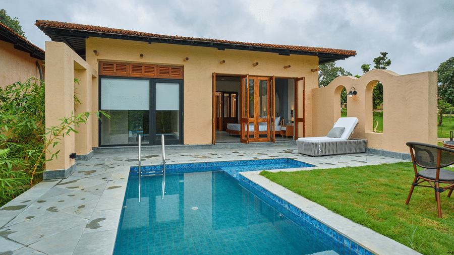 An exterior view featuring a building with a private swimming pool and a grassy lawn at Hotel Sonar Bangla, Ajodhya Hills.