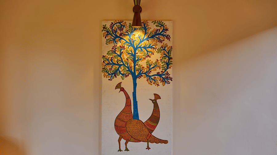 A wall featuring a colourful painting of a tree and 2 birds at Hotel Sonar Bangla, Ajodhya Hills.