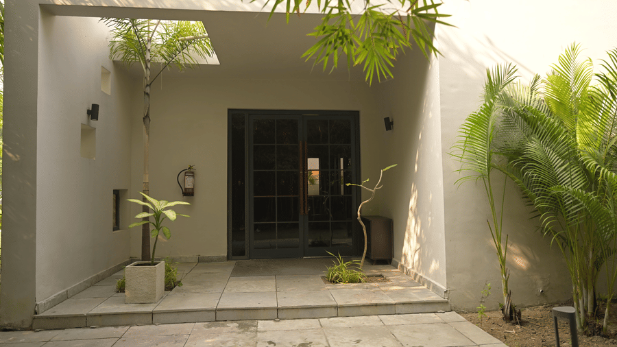 A spa entrance framed by plants at Hotel Sonar Bangla, Mayapur.