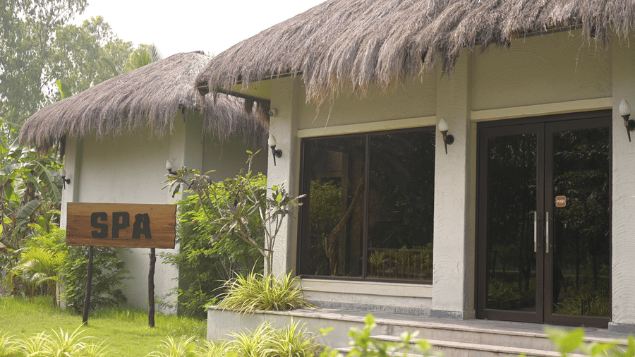 Front view of the spa building entrance with concrete steps and a thatched roof at Hotel Sonar Bangla, Sundarban.
