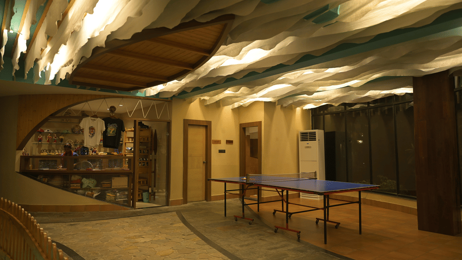 Room featuring a blue table tennis table and a textured ceiling at Hotel Sonar Bangla, Sundarban.