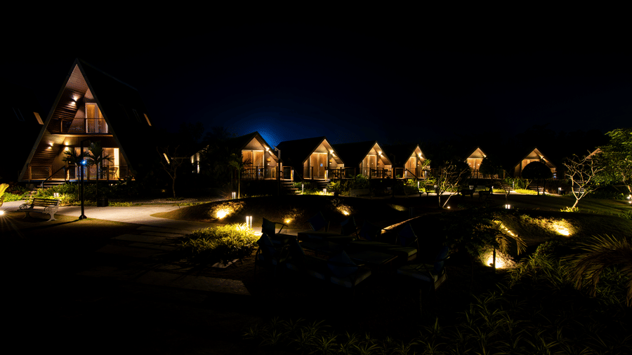 Cluster of illuminated villa units and 1 Duplex villa reflected at night at Hotel Sonar Bangla, Taki.