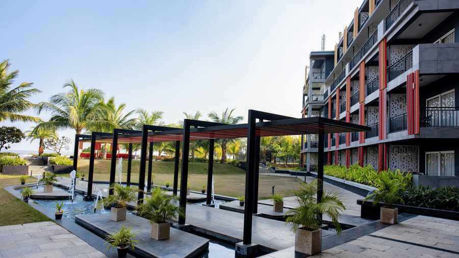 Daytime view of the hotel exterior featuring a walkway at Hotel Sonar Bangla, Taki.