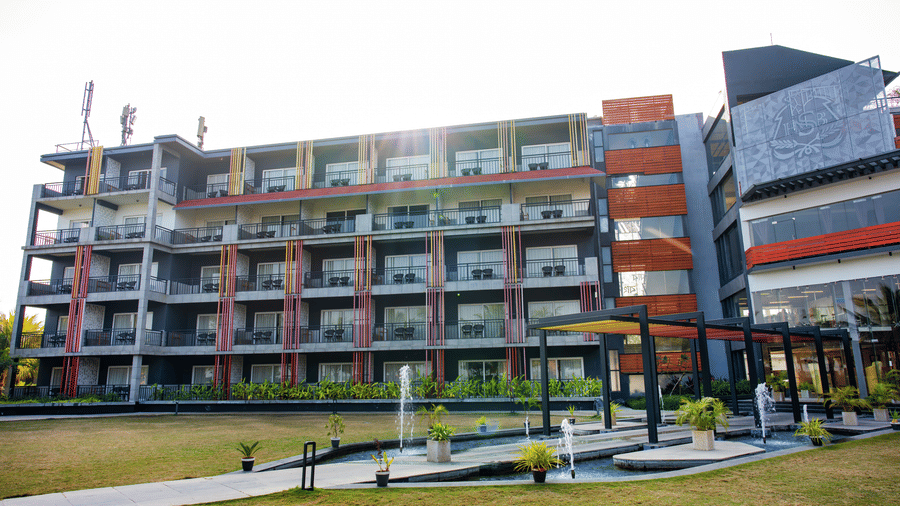 Wide view of the hotel building exterior from the lawn at Hotel Sonar Bangla, Taki.