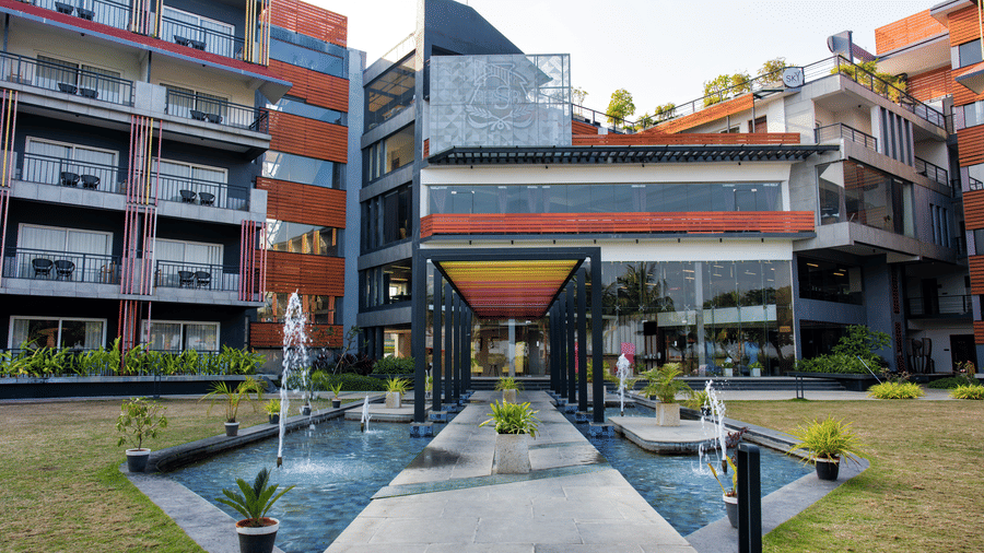 Front entrance of Hotel Sonar Bangla, Taki, with fountains and landscaping.