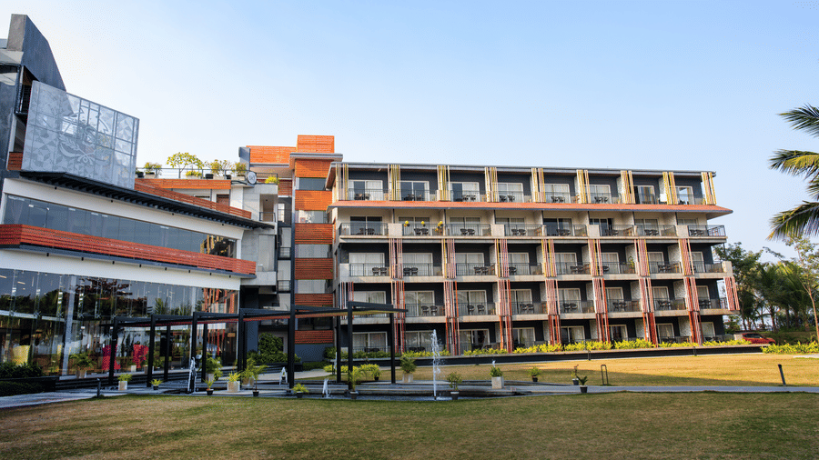 Wide-angle exterior view of the hotel building at Hotel Sonar Bangla, Taki.