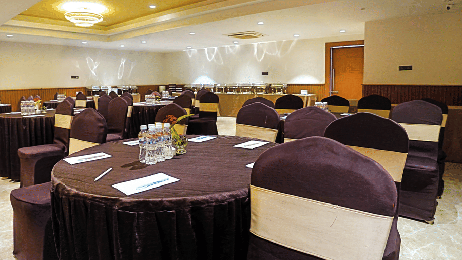 Close-up shot of banquet tables in the Ganga hall at Hotel Sonar Bangla, Taki.