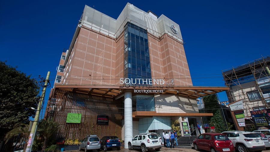 A daytime view of the Southend Hotel with a clear blue sky and parked cars - Hotel Southend by TGI - Bommasandra, Bangalore