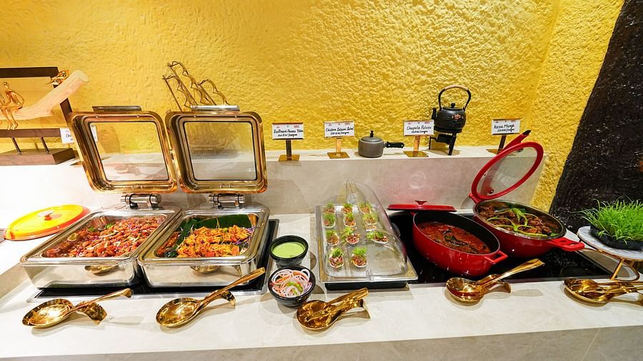  An assorted buffet spread featuring trays of Indian snacks and chutneys. - Tara, Comfort Hotel in Hyderabad - Ramoji Film City.