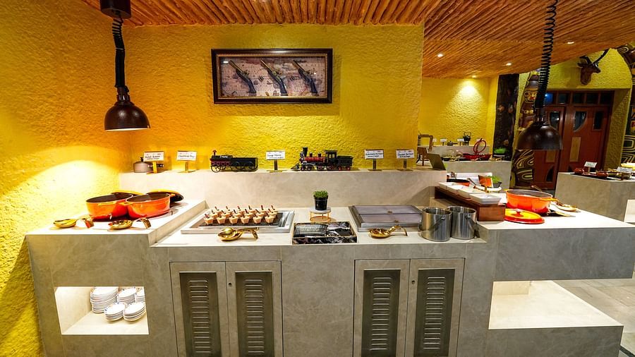 An expansive view of a restaurant buffet with neatly organized serving areas. - Tara, Comfort Hotel in Hyderabad - Ramoji Film City.