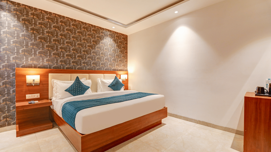 Spacious hotel room showing bedside tables, warm accent lighting, and elegant decor - Hotel Velocity