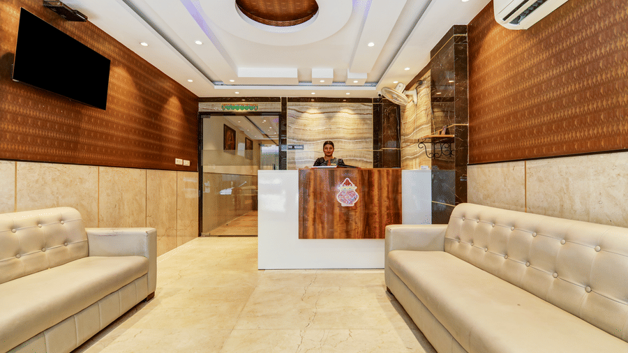 Elegant hotel reception desk and lobby seating area with contemporary lighting - Hotel Velocity