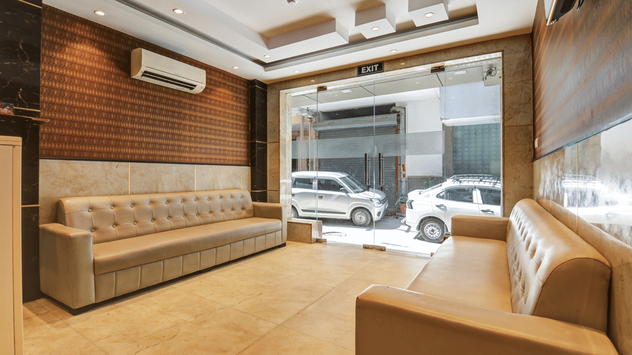 View from the lobby interior looking towards the street-facing entrance and lounge seating - Hotel Velocity