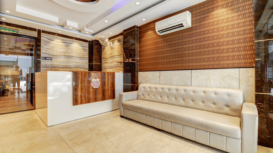Side view of the modern reception desk and comfortable lounge seating - Hotel Velocity