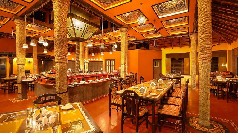 brightly lit Kokam Restaurant at Hoysala Village Resort, Hassan