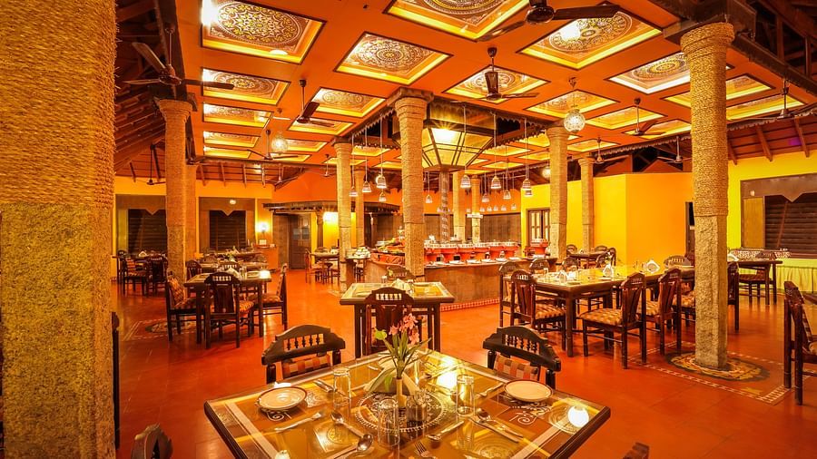 brightly lit Kokam Restaurant at Hoysala Village Resort, Hassan