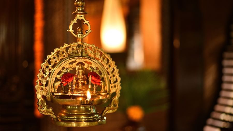 a bronze oil lamp with a goddess figure ingrained at Hoysala Village Resort, Hassan