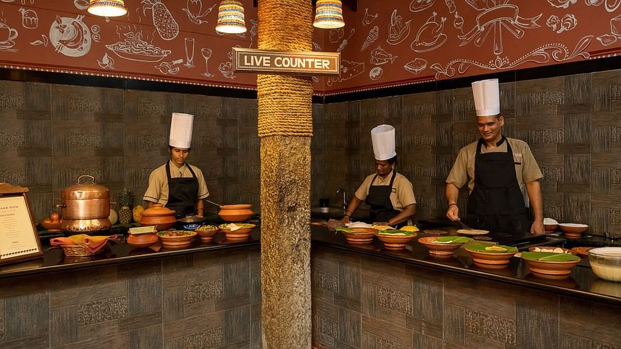 image of three chefs cooking behind the live counter at hoysala village resort, hassan