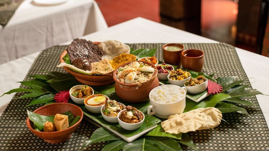 image of a full platter of food served on plantain leaves at Hoysala Village Resort, Hassan