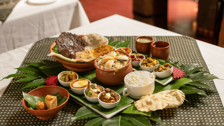 image of a full platter of food served on plantain leaves at Hoysala Village Resort, Hassan