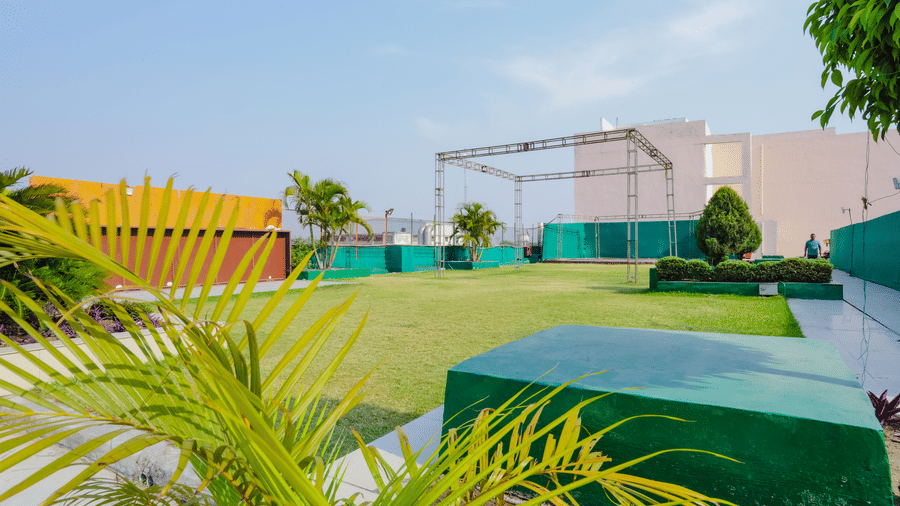 A green lawn and some simple outdoor structures - Hyphen Grand, Haridwar