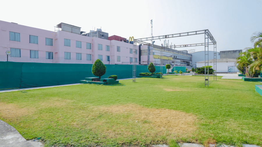 View of the spacious rooftop lawn area with green grass - Hyphen Grand, Haridwar