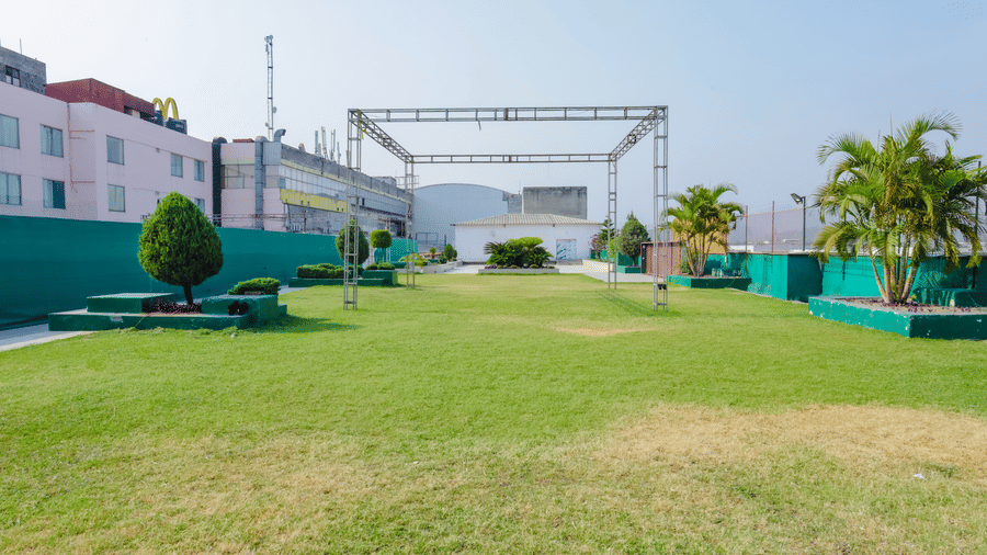 A large outdoor grassy area on a rooftop with clear blue sky - Hyphen Grand, Haridwar