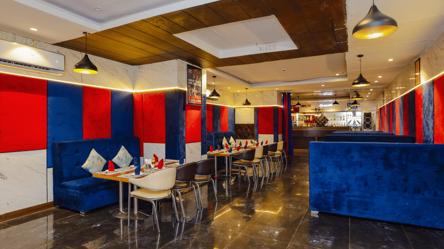 A wide shot of the restaurant interior showcasing multiple dining tables and modern decor - Hyphen Grand, Haridwar
