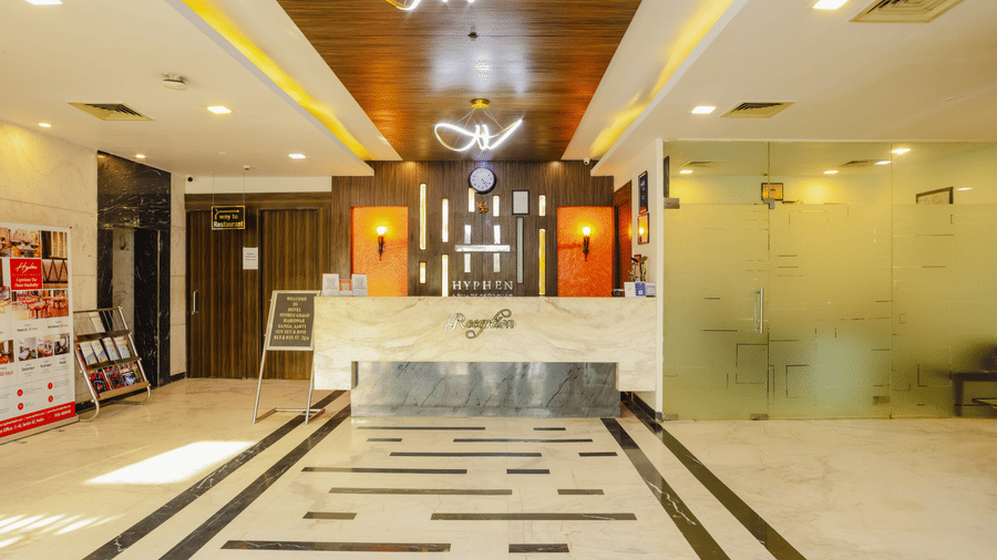 A hotel lobby or common area with a circular design feature and wooden doors - Hyphen Grand, Haridwar