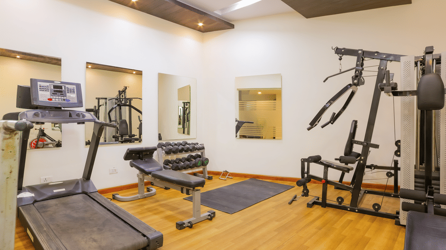 Fully equipped fitness centre with strength training machines at Hyphen Premier Hotel, Meerut.