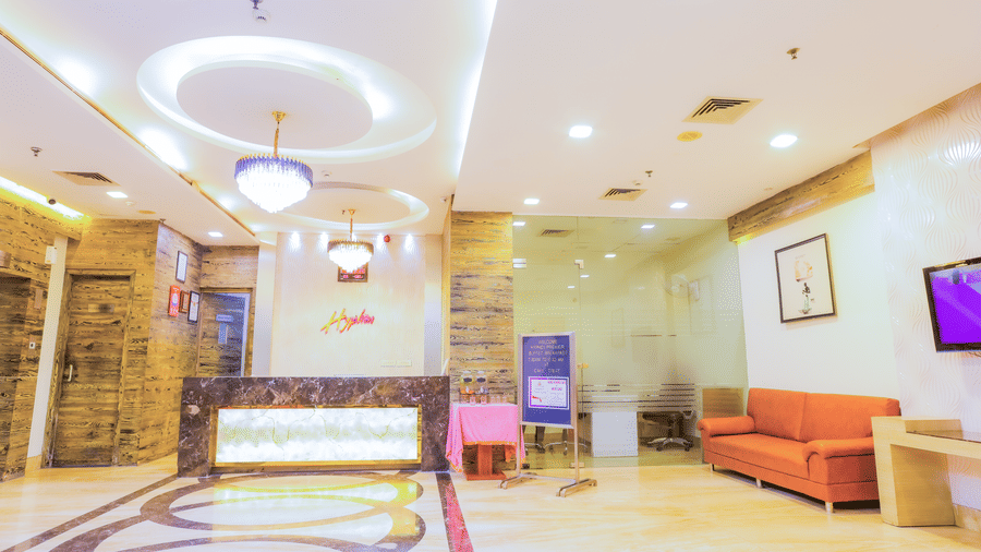 Hotel lobby area with a reception desk and sofa seating area at Hyphen Premier Hotel, Meerut.