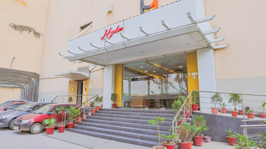 Facade entrance of Hyphen Premier Hotel, Meerut with many steps leading to the hotel building.
