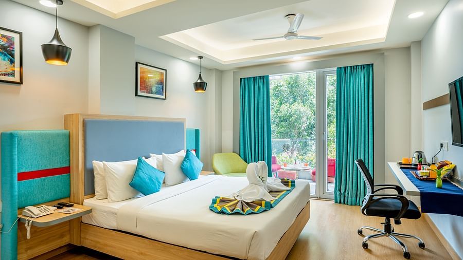 An image of a bedroom with balcony | Inde Hotel Golf Course Extension