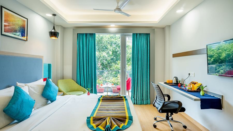 An image of a bedroom with balcony | Inde Hotel Golf Course Extension