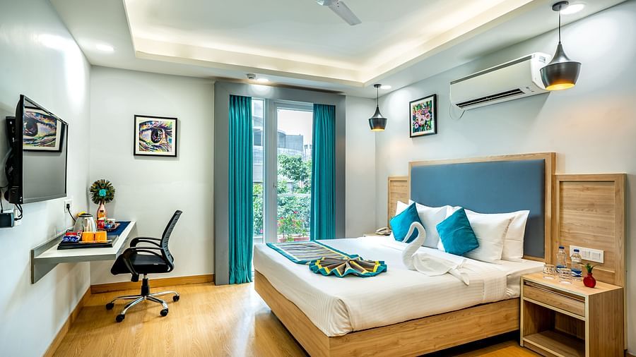 An image of a bedroom with attached balcony | Inde Hotel Golf Course Extension