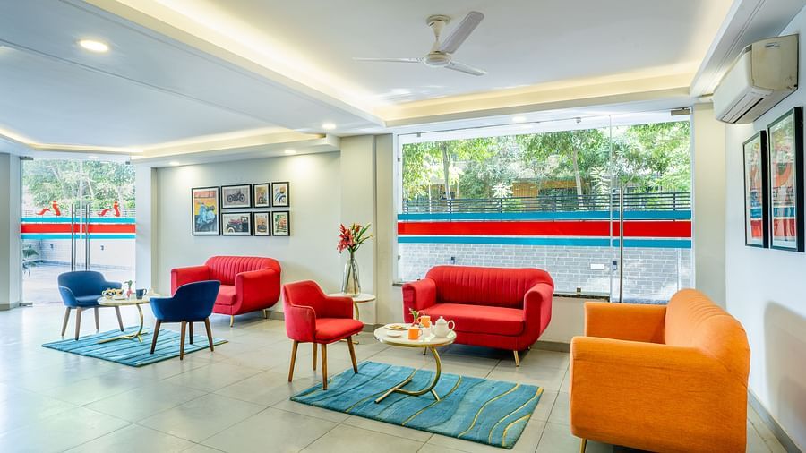 An image of a lobby with two sitting arrangements | Inde Hotel Golf Course Extension