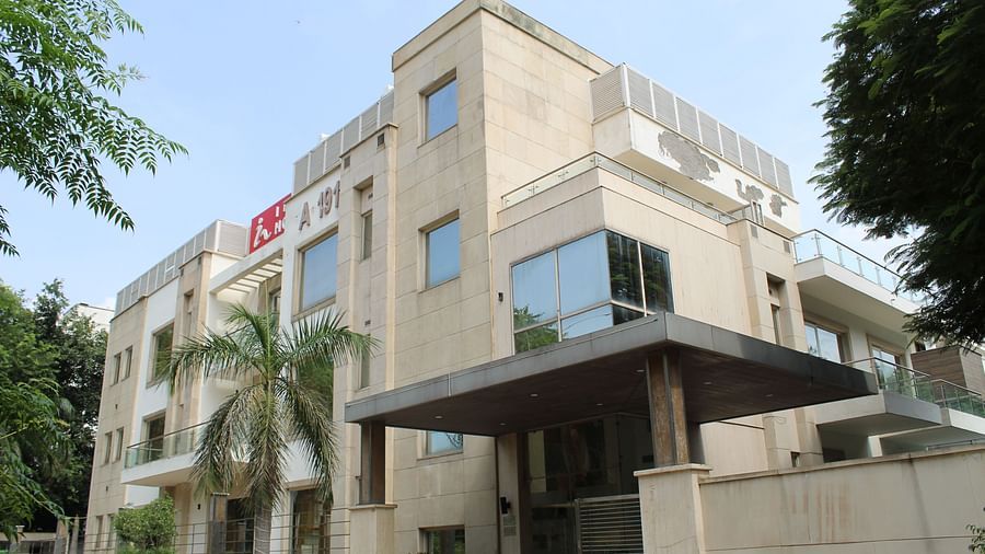 A facade image of Inde Hotels Vista Woods featuring a multi storey building surrounded by trees