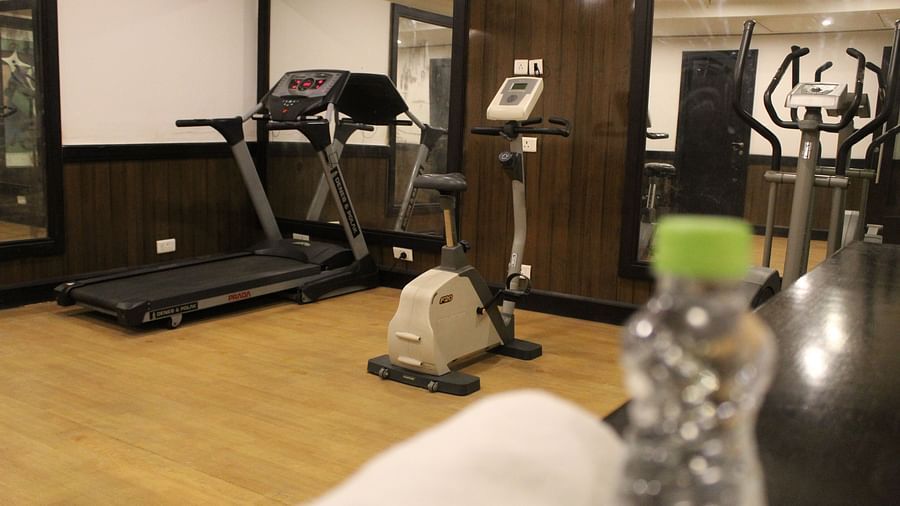 An image of a gym at Inde Hotel Vista Woods featuring treadmill , cardio machine, and other fitness quipment