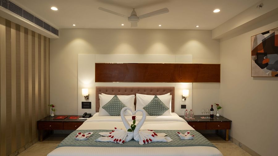 Club Room with a large double bed with decorative amenities artistically arranged at Inde Signature Jaipur