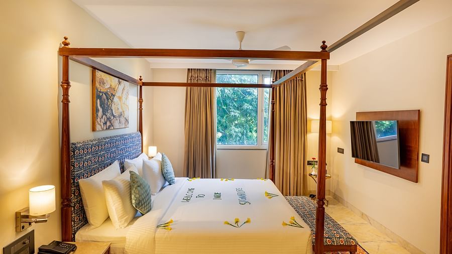 Spacious Suite with double bed, wall mounted television and big windows at Inde Signature Jaipur