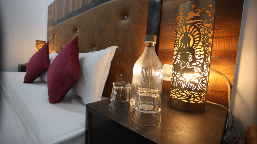 A room with a large bed, pillows, spreads, and lamps | Indus Serinity, Leh Ladakh