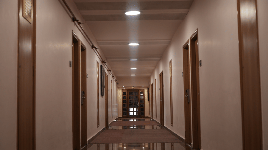 Infiniti Hotel, Indore | An elongated path with several doors.
