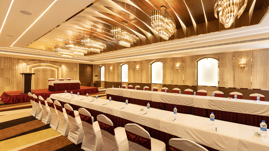 A corporate training setup featuring long tables and chairs arranged in a classroom style - Jenneys Residency, Coimbatore
