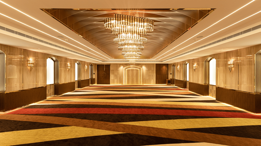 view of an empty hall with chandelier lights2