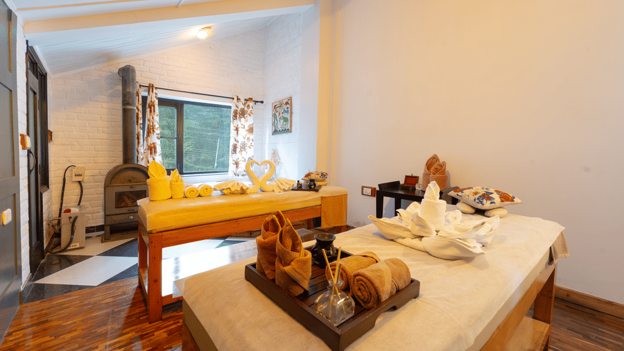 A serene spa treatment room with professional massage tables and decorative towels - Johnson Lodge & Spa, Manali